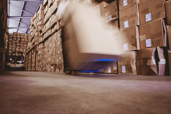 worker-with-fork-pallet-truck-stacker-in-warehouse